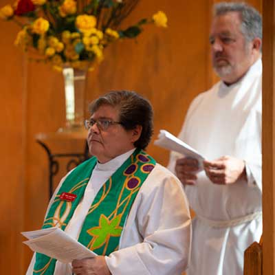 The Rev. Jamie Samilio giving the Holy Eucharist